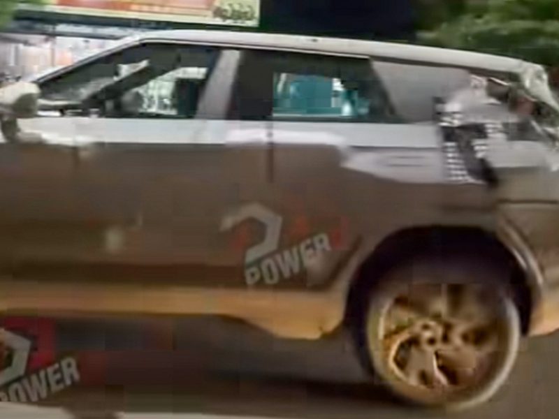 Mahindra BE 7 electric SUV spy shot showing triple-screen dashboard and frameless doors design